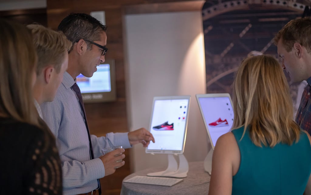Guests customizing sneakers on an tablet